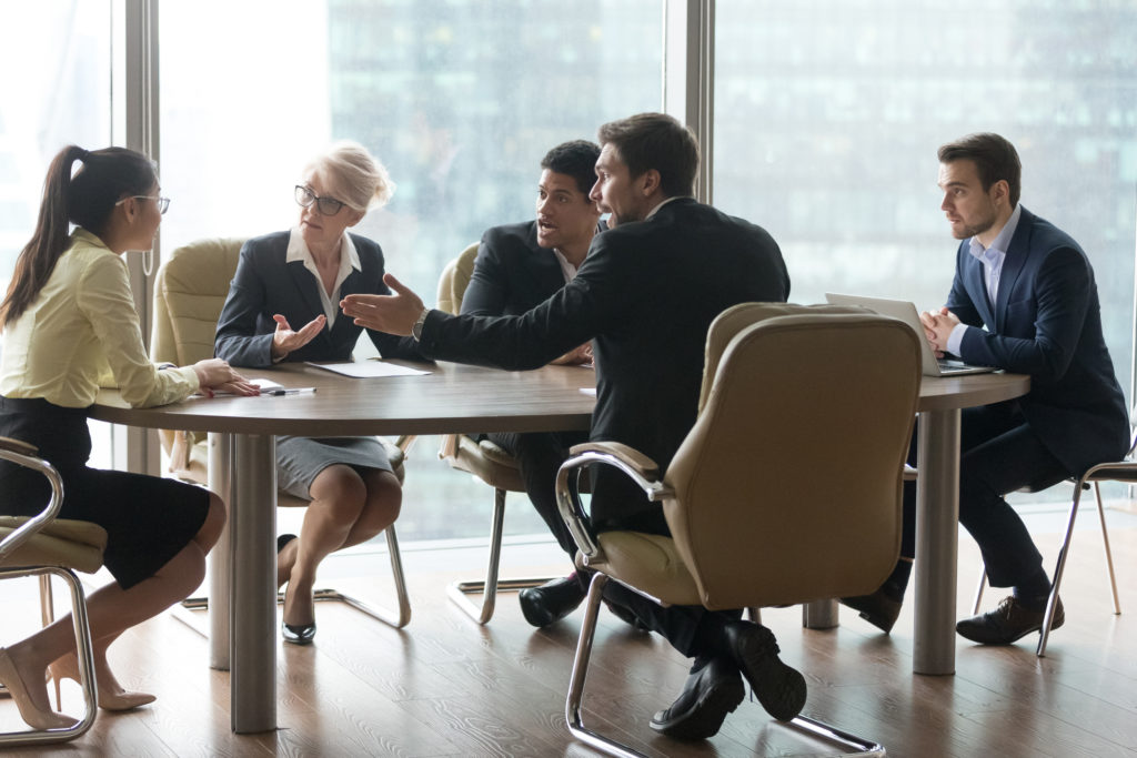 Business team arguing in meeting