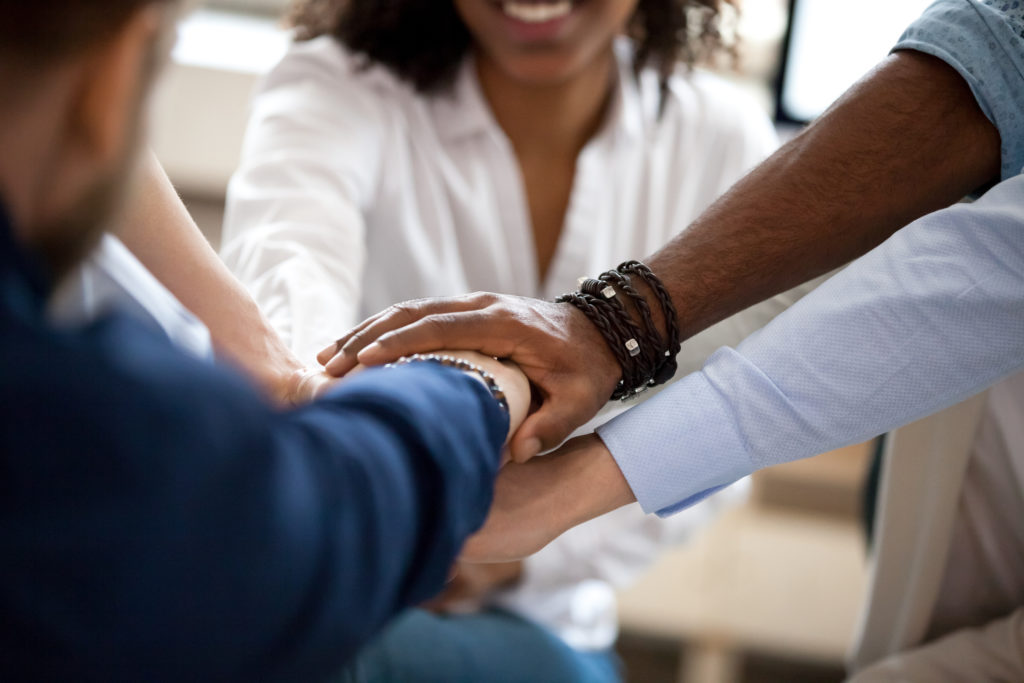 Business team putting hands together