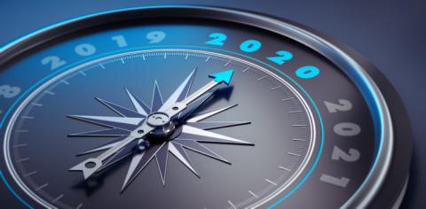 Dark stylish compass with needle pointing to the year 2020