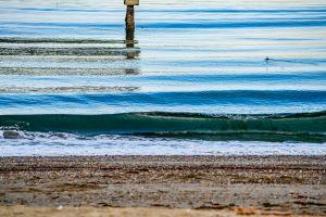 A photograph of sea waves at the shoreline. 