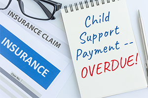 notebook indicating that child support payment is overdue