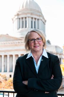 State Auditor Pat McCarthy stands in front of the capital building in Olympia